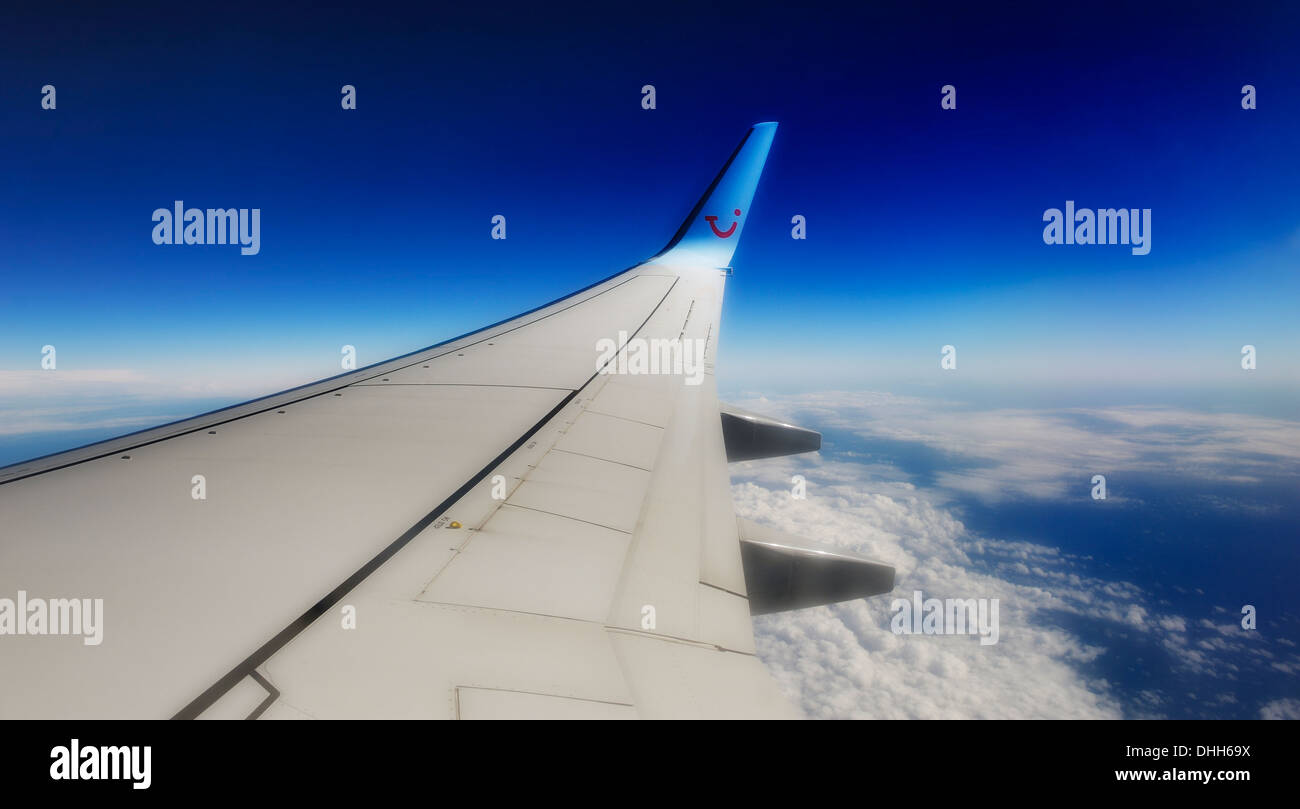 wing of TUI boeing 757-200 aeroplane in flight at 36000 feet Stock Photo