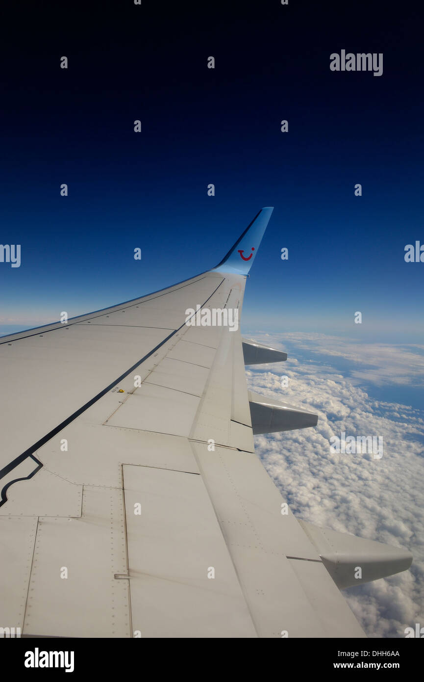 wing of TUI boeing 757-200 aeroplane in flight at 36000 feet Stock Photo