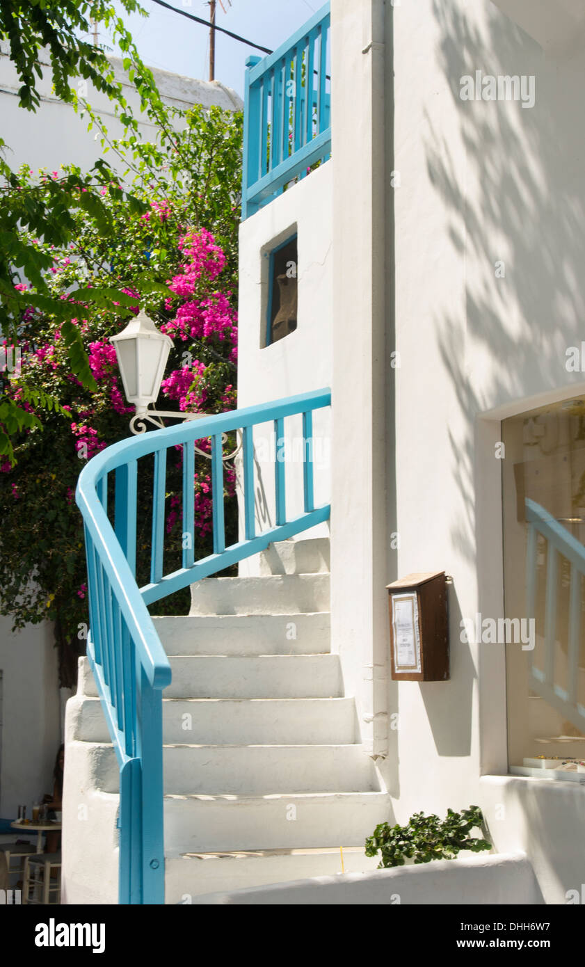 Mykonos Greece blue stairs and flowers in Mykonos Center downtown beautiful scenic Stock Photo