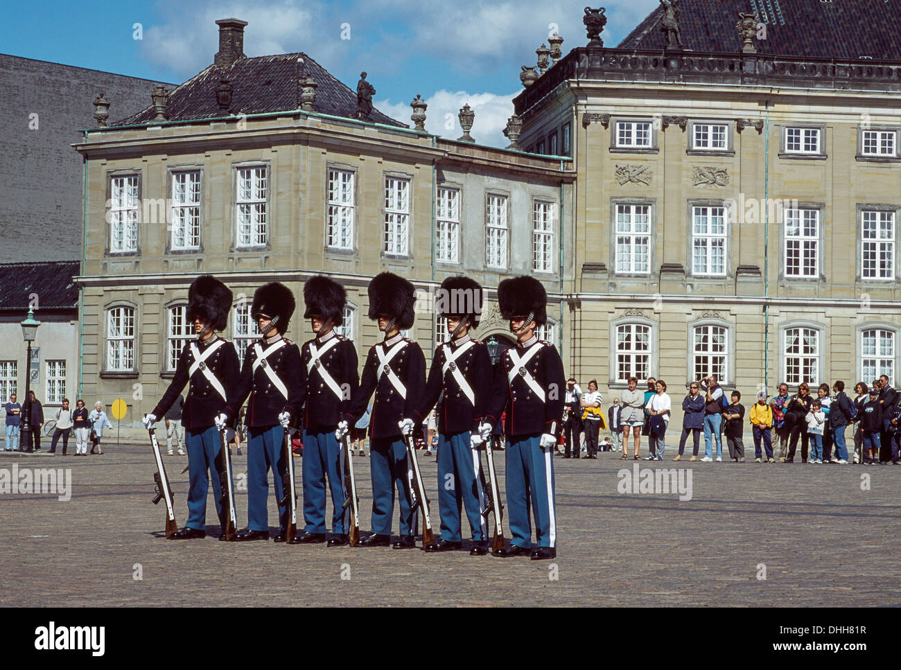 GUARDS IN UNIFORM WITH BEARSKIN HEADGEAR AT AMALIENBORG PALACE COPENHAGEN DENMARK Stock Photo