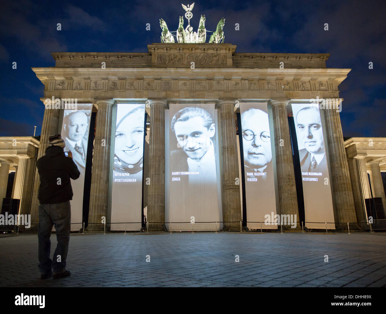 Berlin, Germany. 10th Nov, 2013. A man photographs projections on the ...