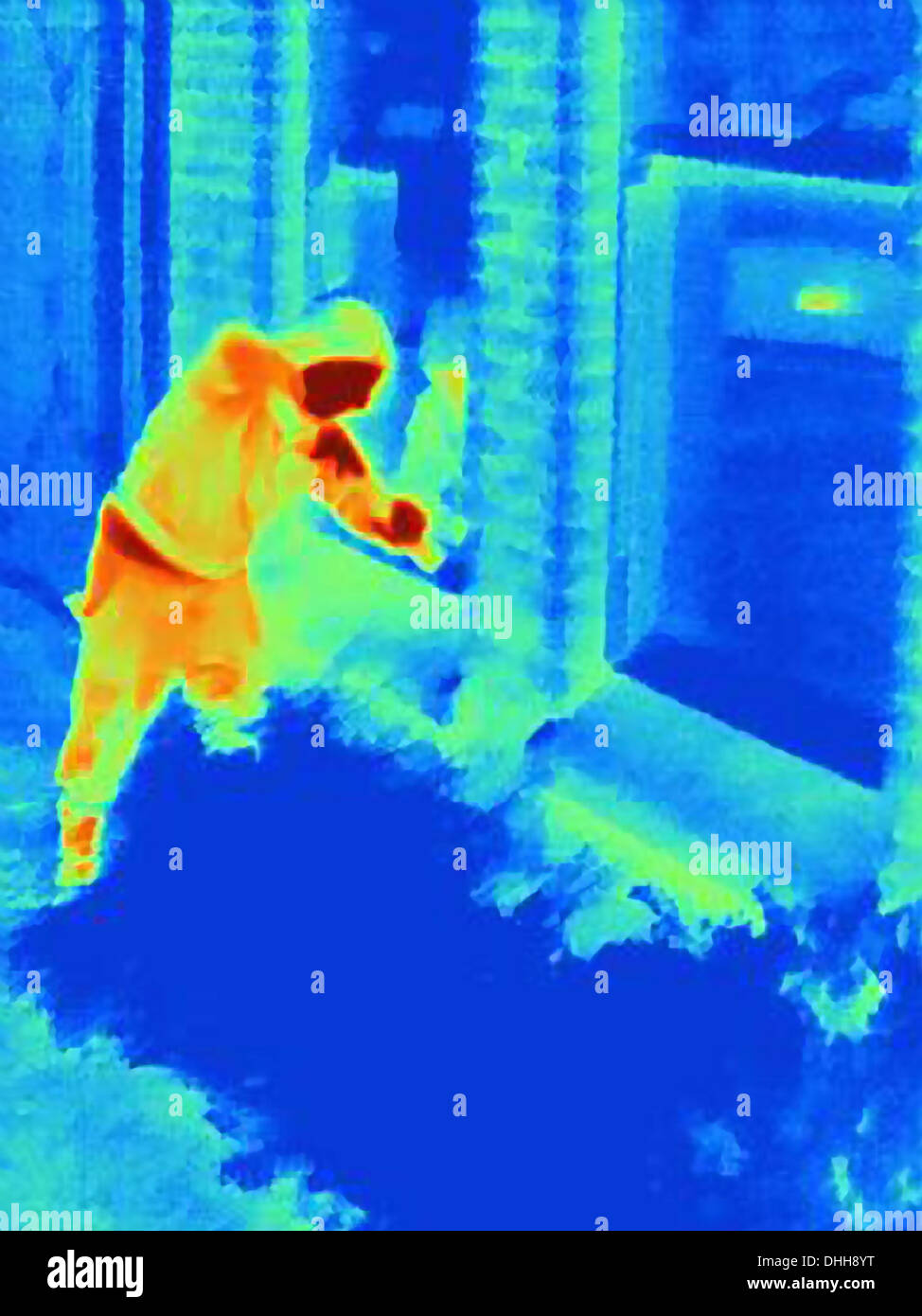 Thermal photograph of a burglar breaking into a house Stock Photo