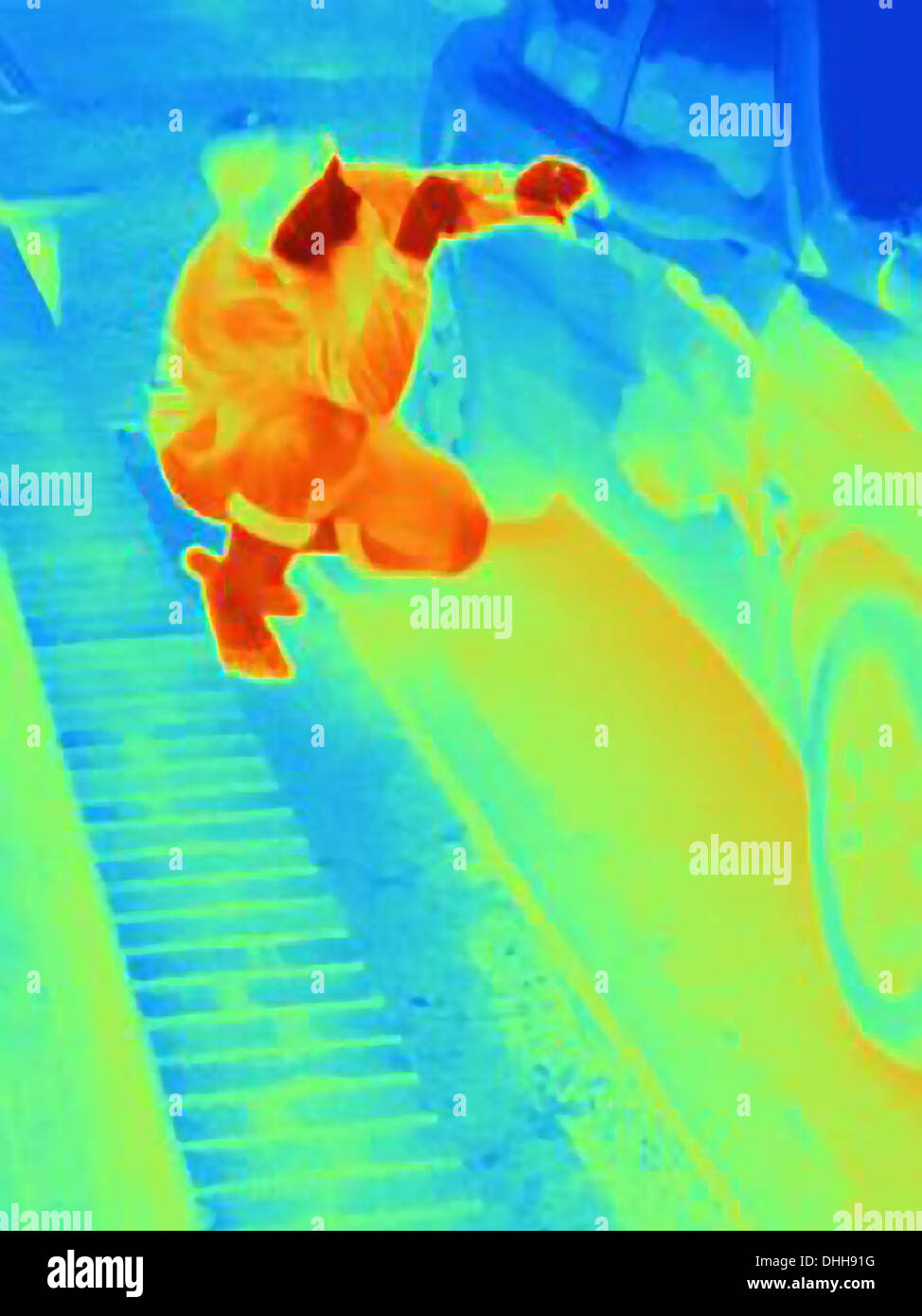 Thermal photograph of a burglar breaking into a car Stock Photo