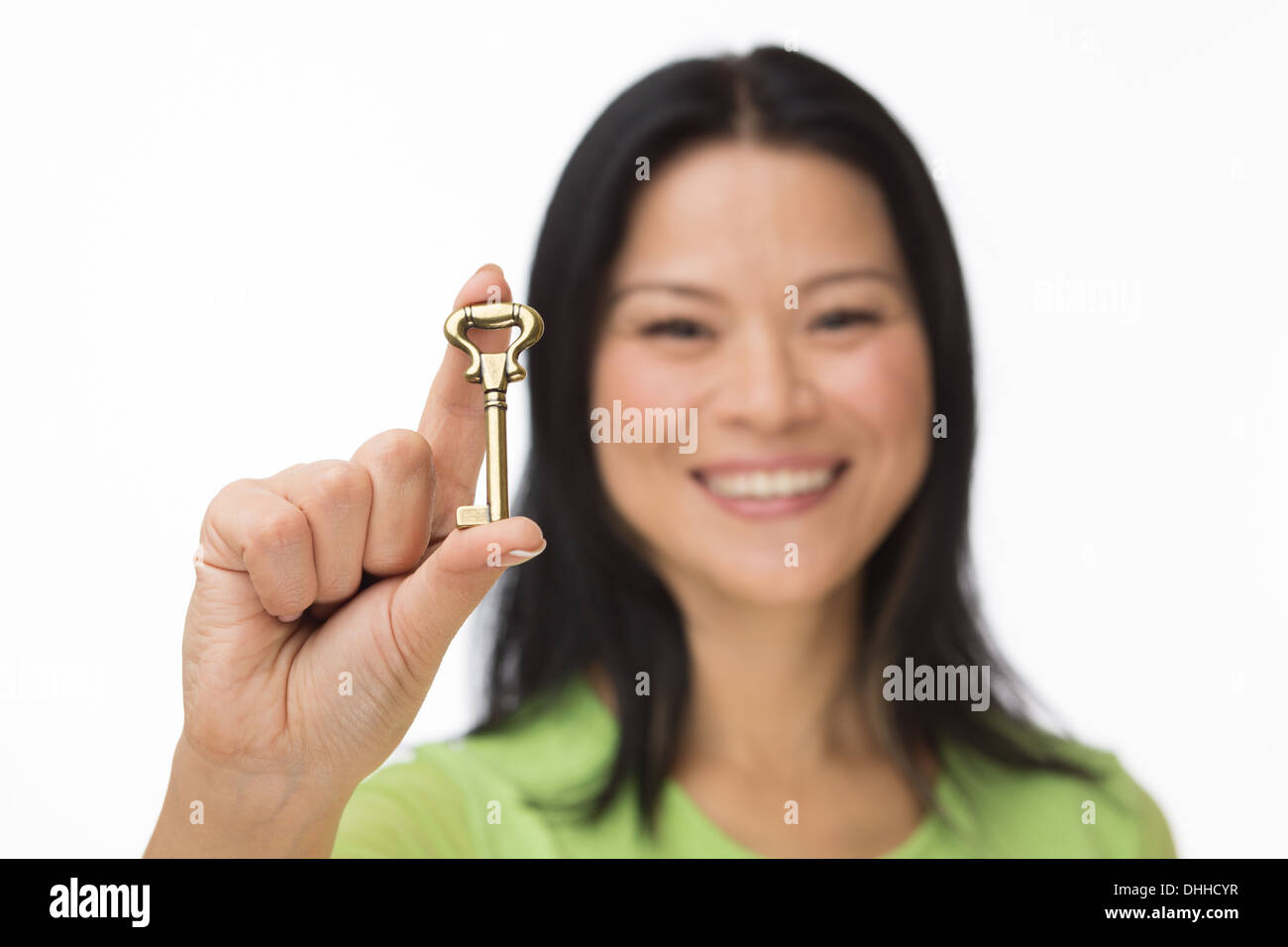 Asian woman hold old key on white Stock Photo - Alamy