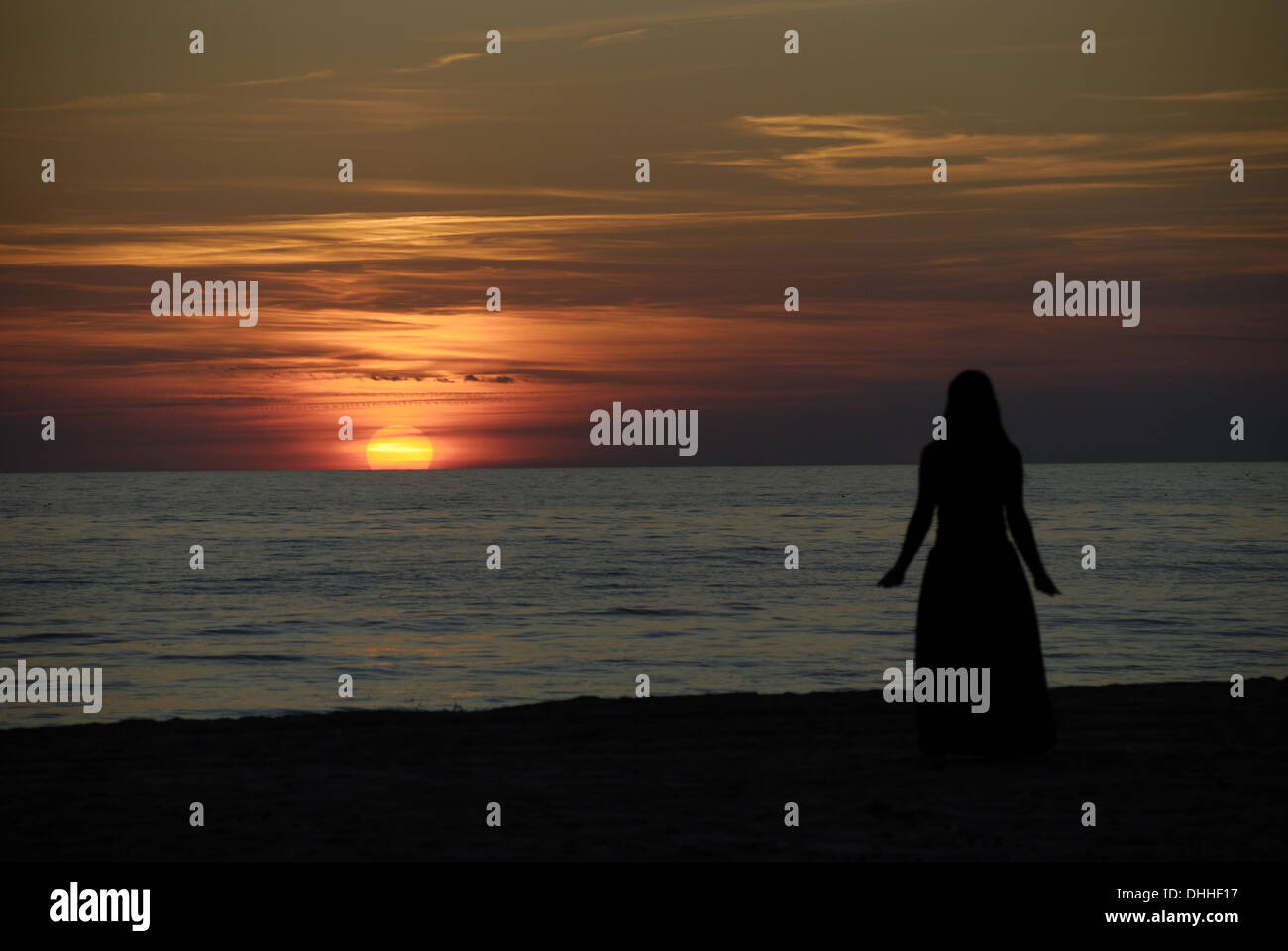 Woman on Ventspils Beach at Sunset Stock Photo