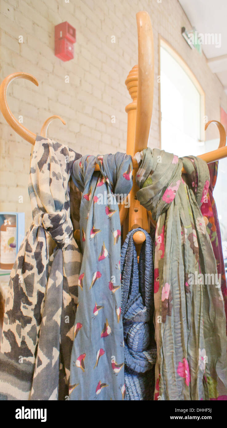 Ladies' scarves hanging on a wooden stand in a shop Stock Photo Alamy