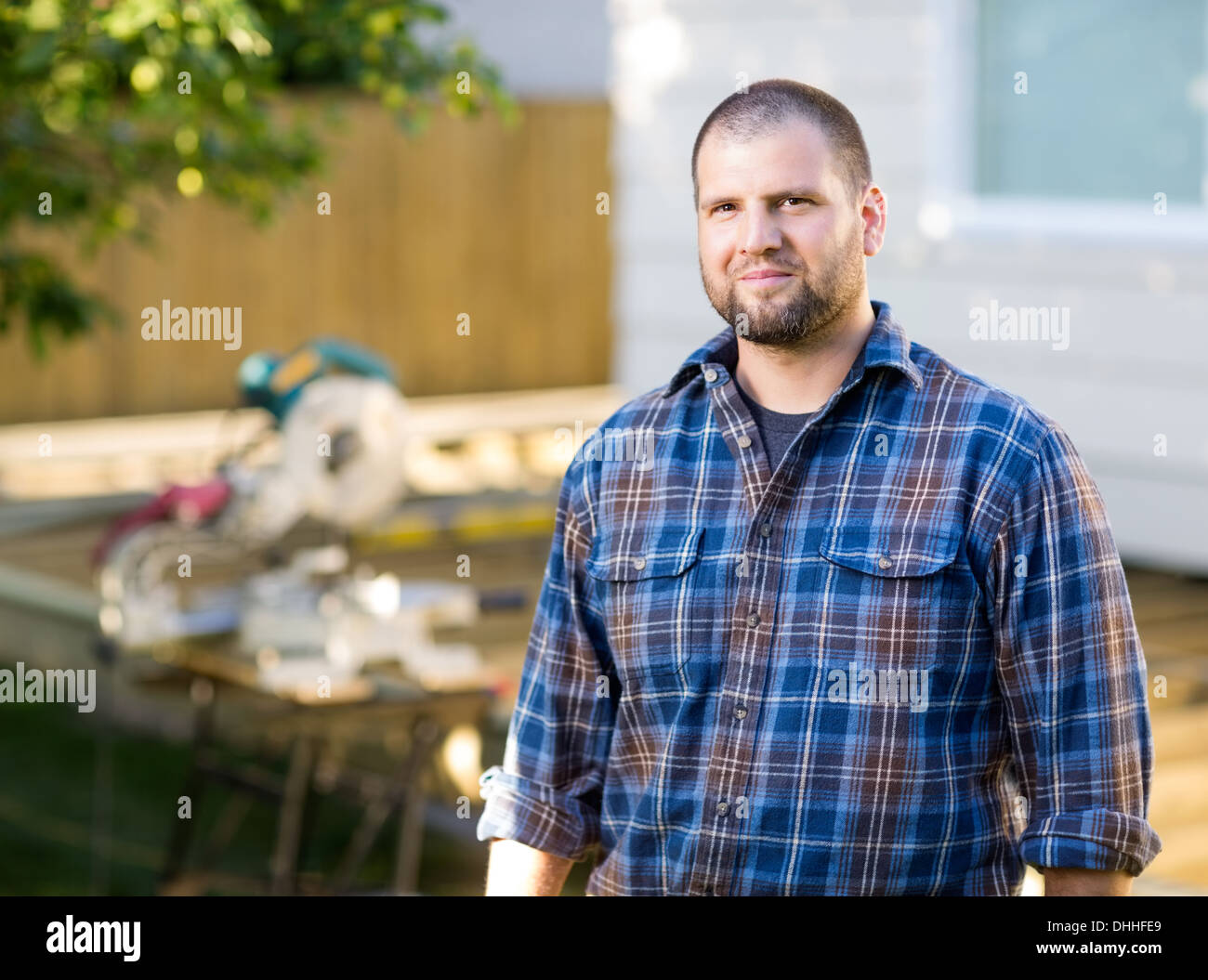 Confident Manual Worker Standing At Construction Site Stock Photo