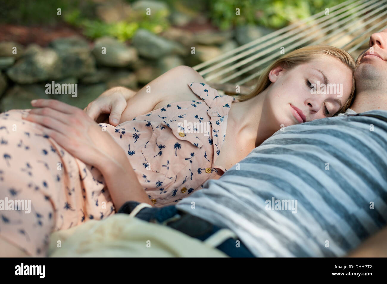 Young couple asleep in hammock Stock Photo