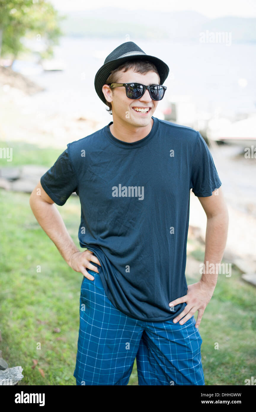 Portrait of young man wearing hat and sunglasses Stock Photo