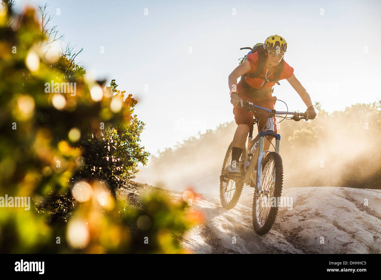 Woman cycling over rocks hi-res stock photography and images - Alamy