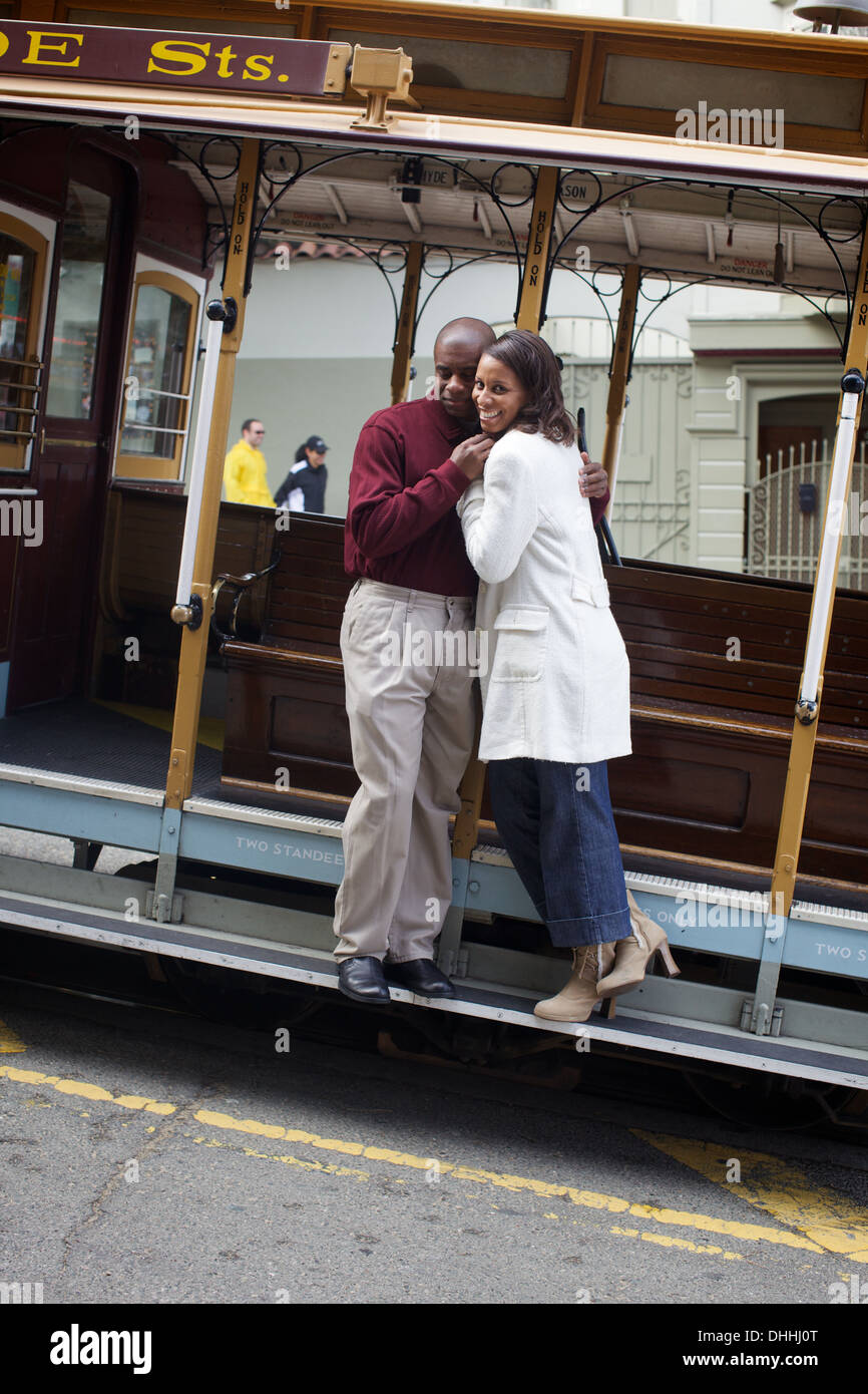 Lovely young black couple frolic on a San Francisco street car, Rice-a-Roni optional. Stock Photo