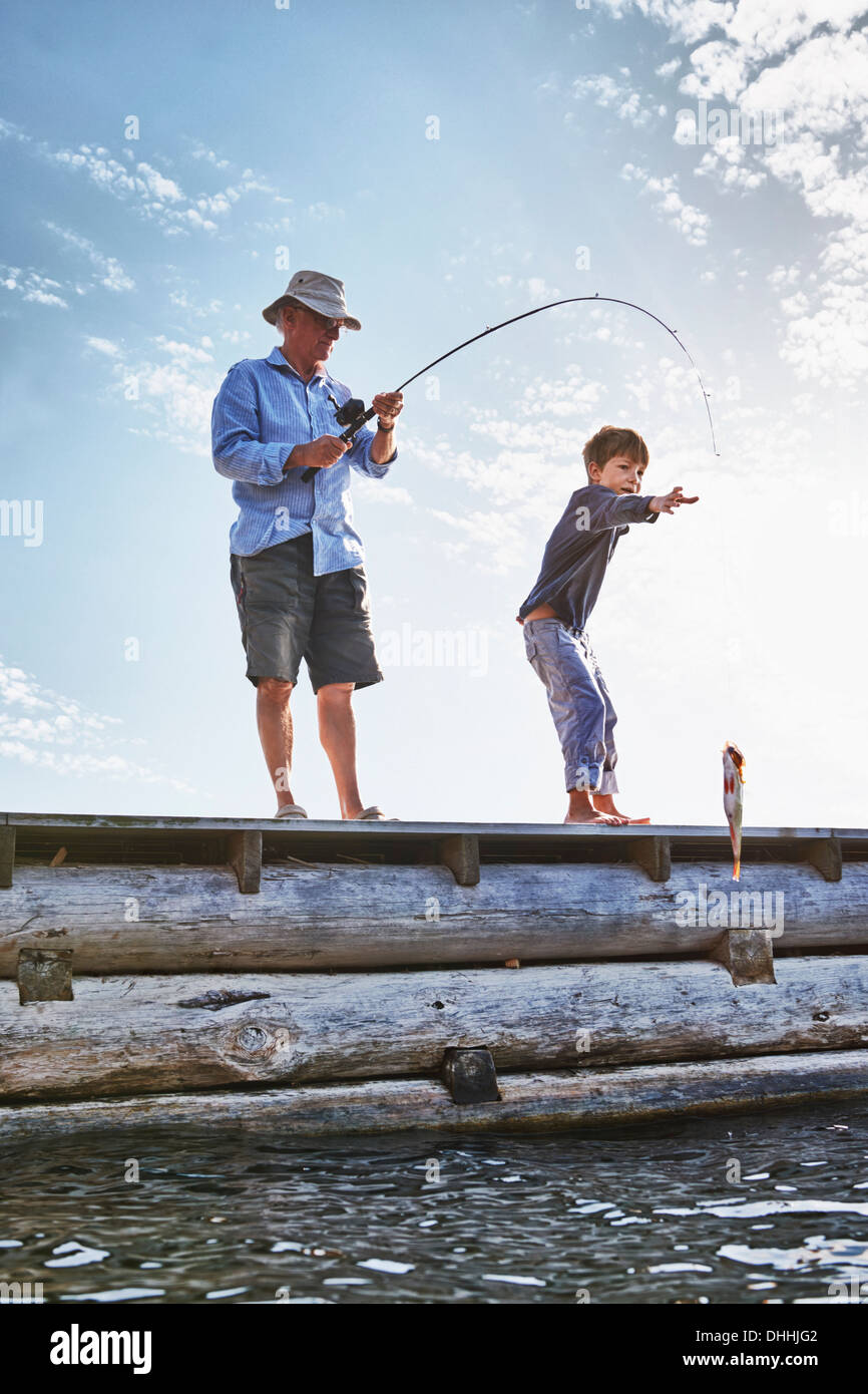 Grandfather and grandson fishing, Utvalnas, Sweden Stock Photo