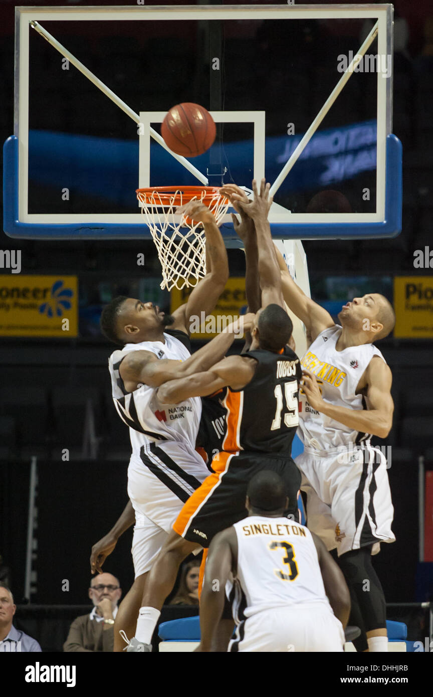 Back to back league champions, the London Lightning improved their record to 1-2 defeating the Ottawa Skyhawks on November 9, 2013 in London Ontario, Canada in a National Basketball League of Canada game.  Marvin Phillips, left and Garrett Williamson defend against Justin Tubbs (15). Stock Photo