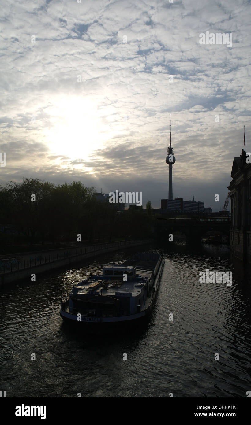 Mackerel sky dawn sunrise portrait, Monbijoubrucke to Alexanderplatz TV Tower, barge passing Bode Museum, River Spree, Berlin Stock Photo