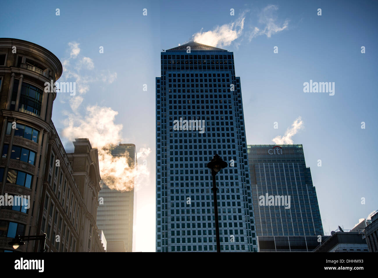 Steam rising off buildings in Canary Wharf at sunrise Stock Photo - Alamy
