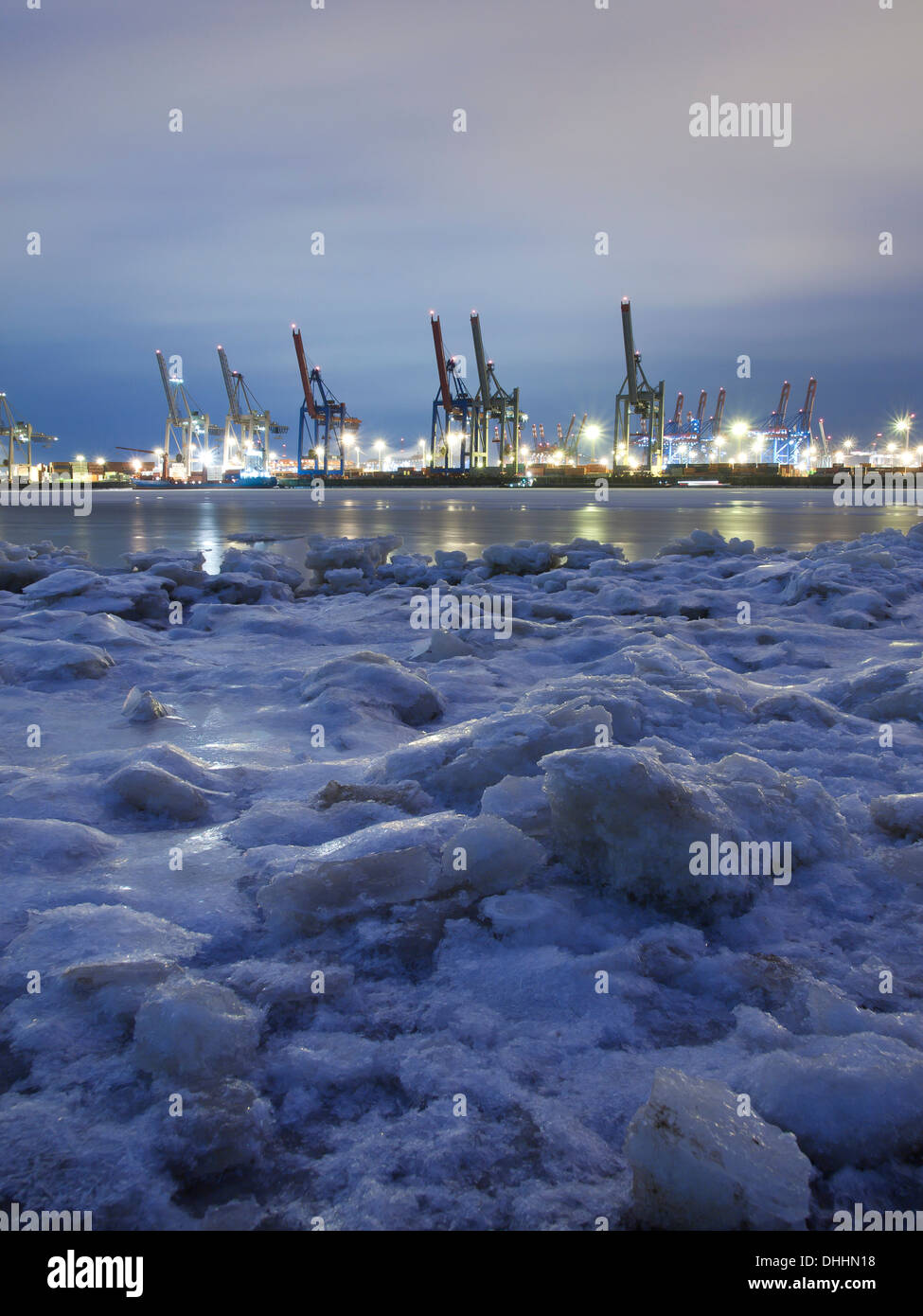 Frozen Elbe river with Waltershof container terminal in the evening, Hanseatic City of Hamburg, Germany, Europe Stock Photo