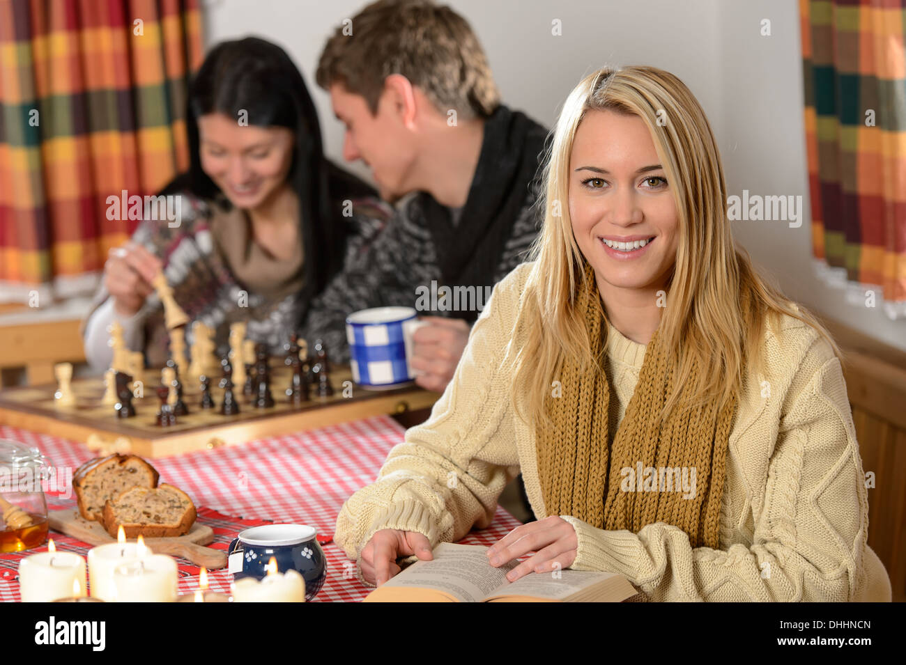 Young people spend winter holiday country cottage playing chess Stock Photo