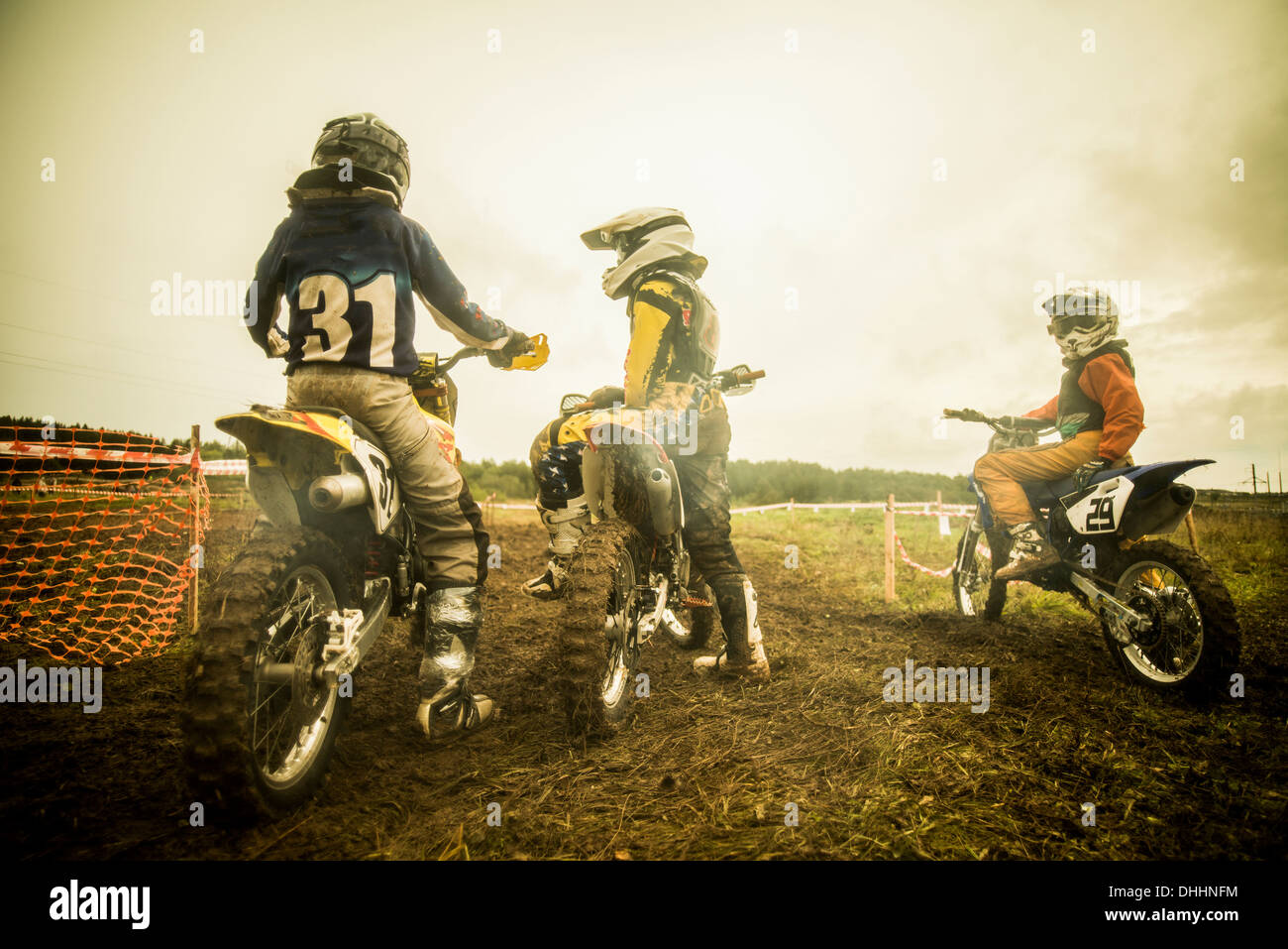 Young man and boys on motorcycles at motocross Stock Photo