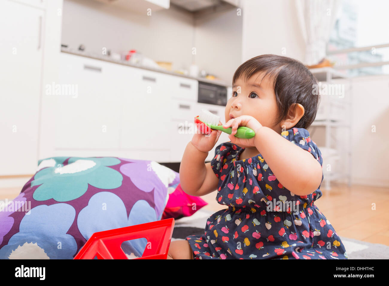 Baby girl playing on floor Stock Photo