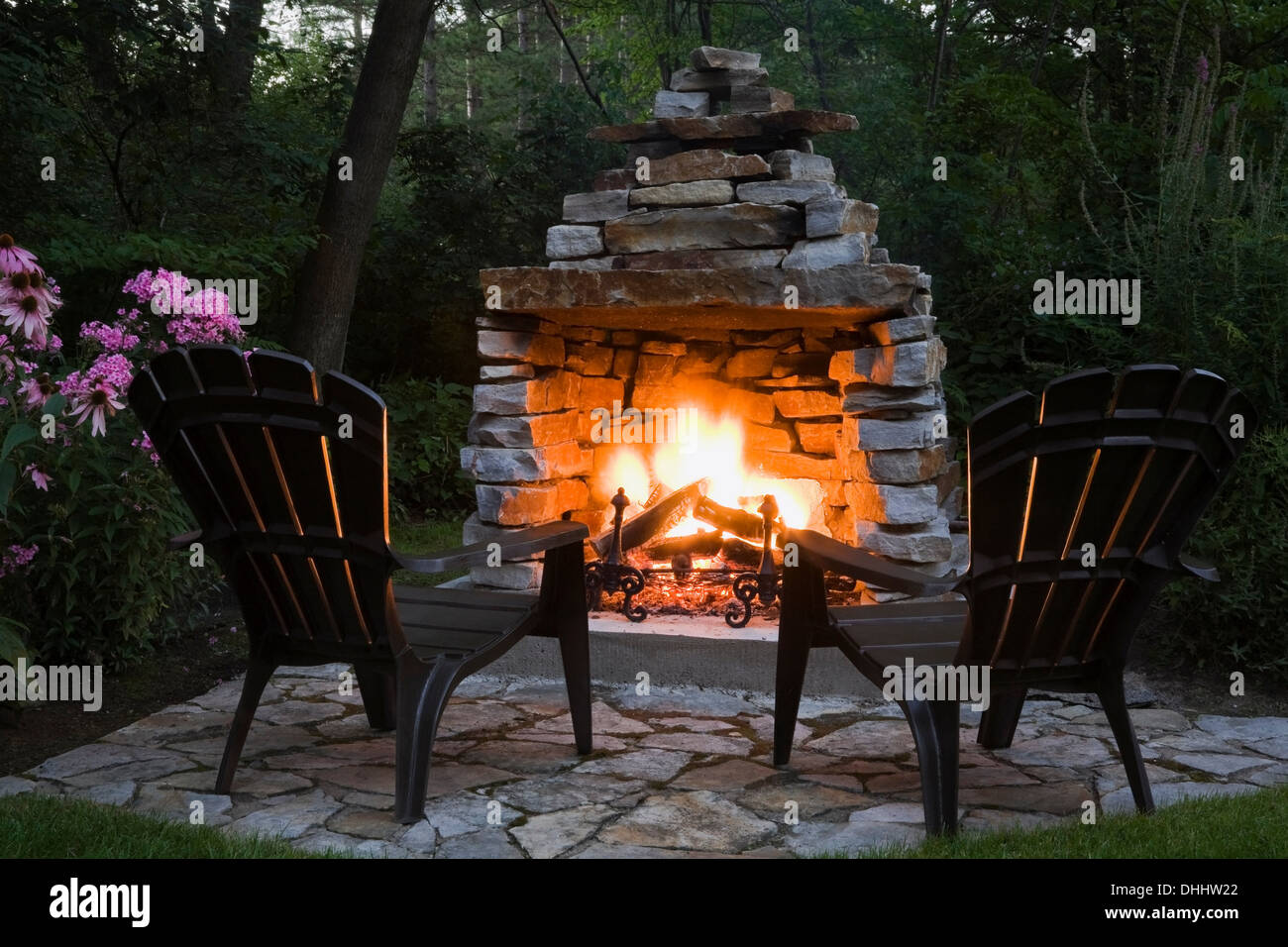 Two chairs in front of outdoor fireplace Stock Photo Alamy