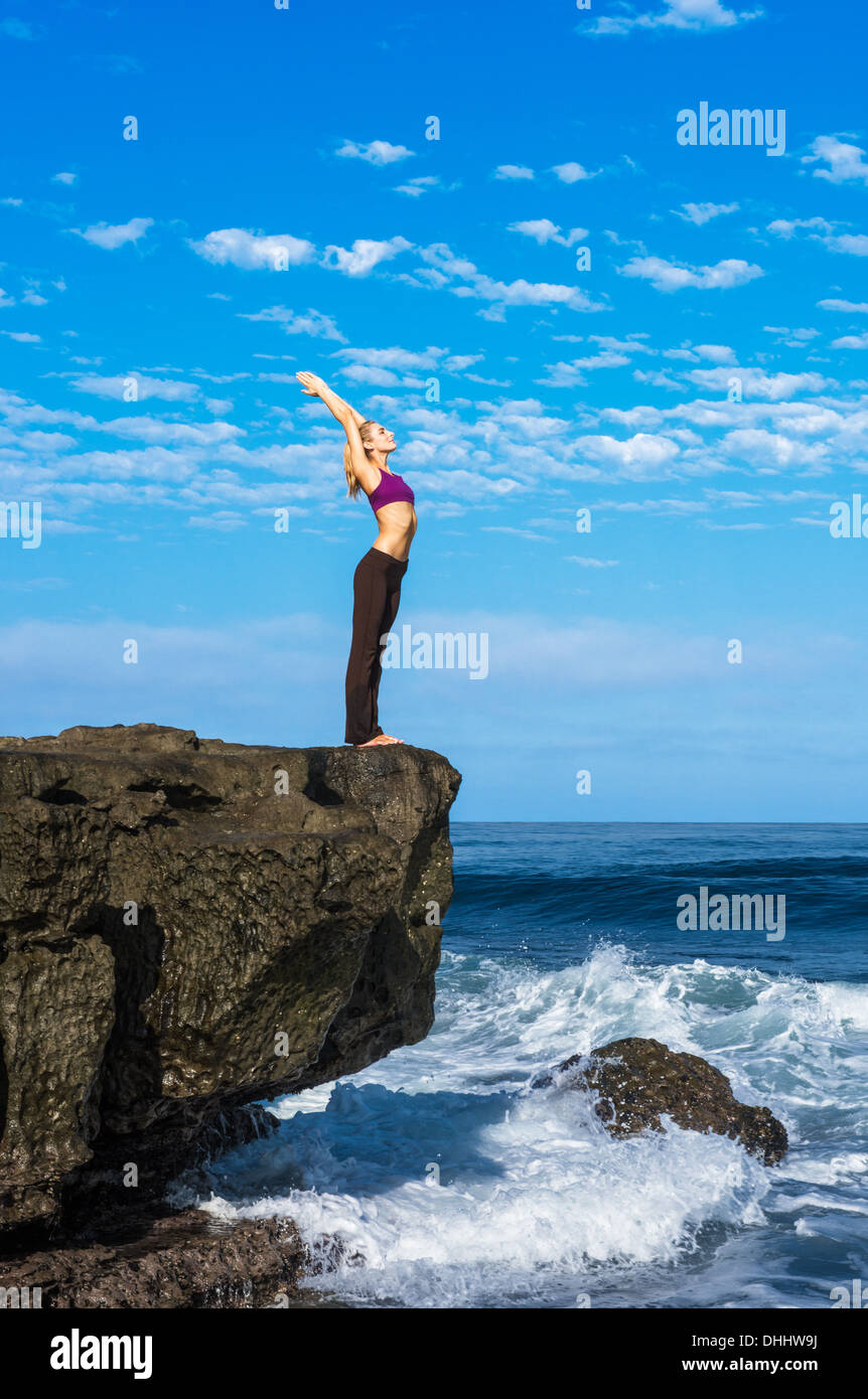 Woman doing yoga at coast Stock Photo