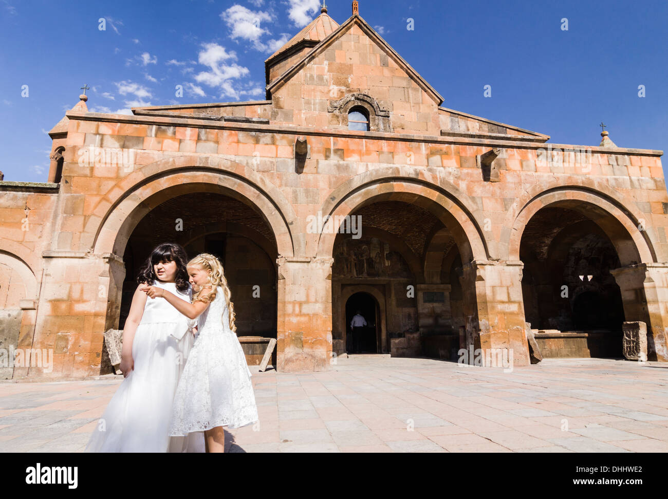 Two girls dressed in white, guests at a wedding at Surp Gayane church. Echmiadzin, Armenia Stock Photo