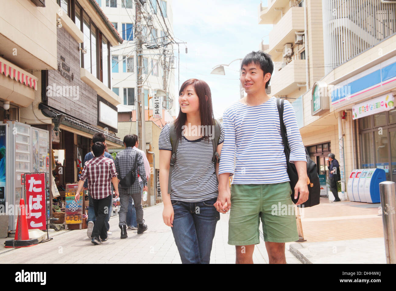 Young couple holding hands walking through Kamakura, Japan Stock Photo