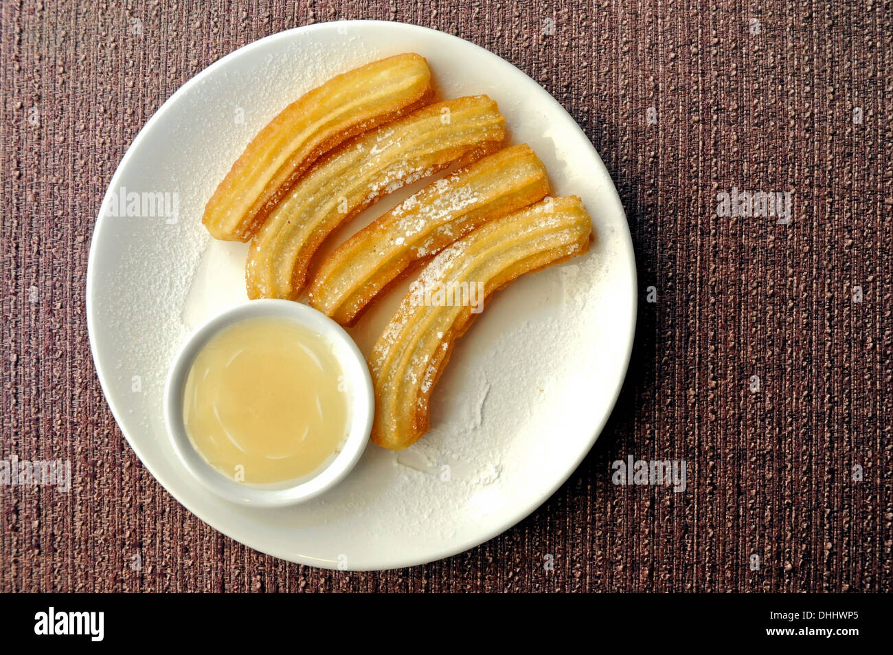 Spanish Churro with milk chocolate dipping Stock Photo