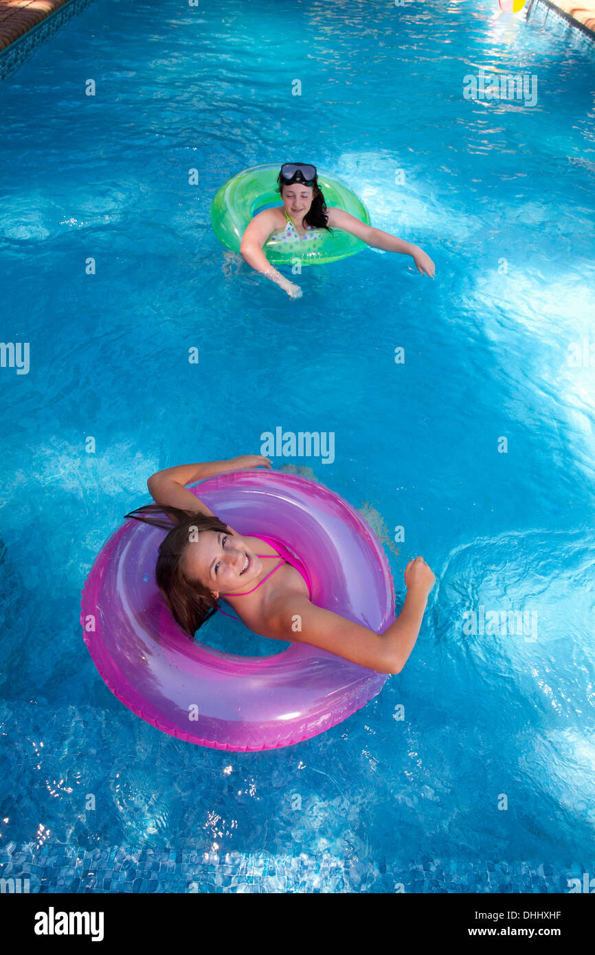 Friends playing in pool Stock Photo