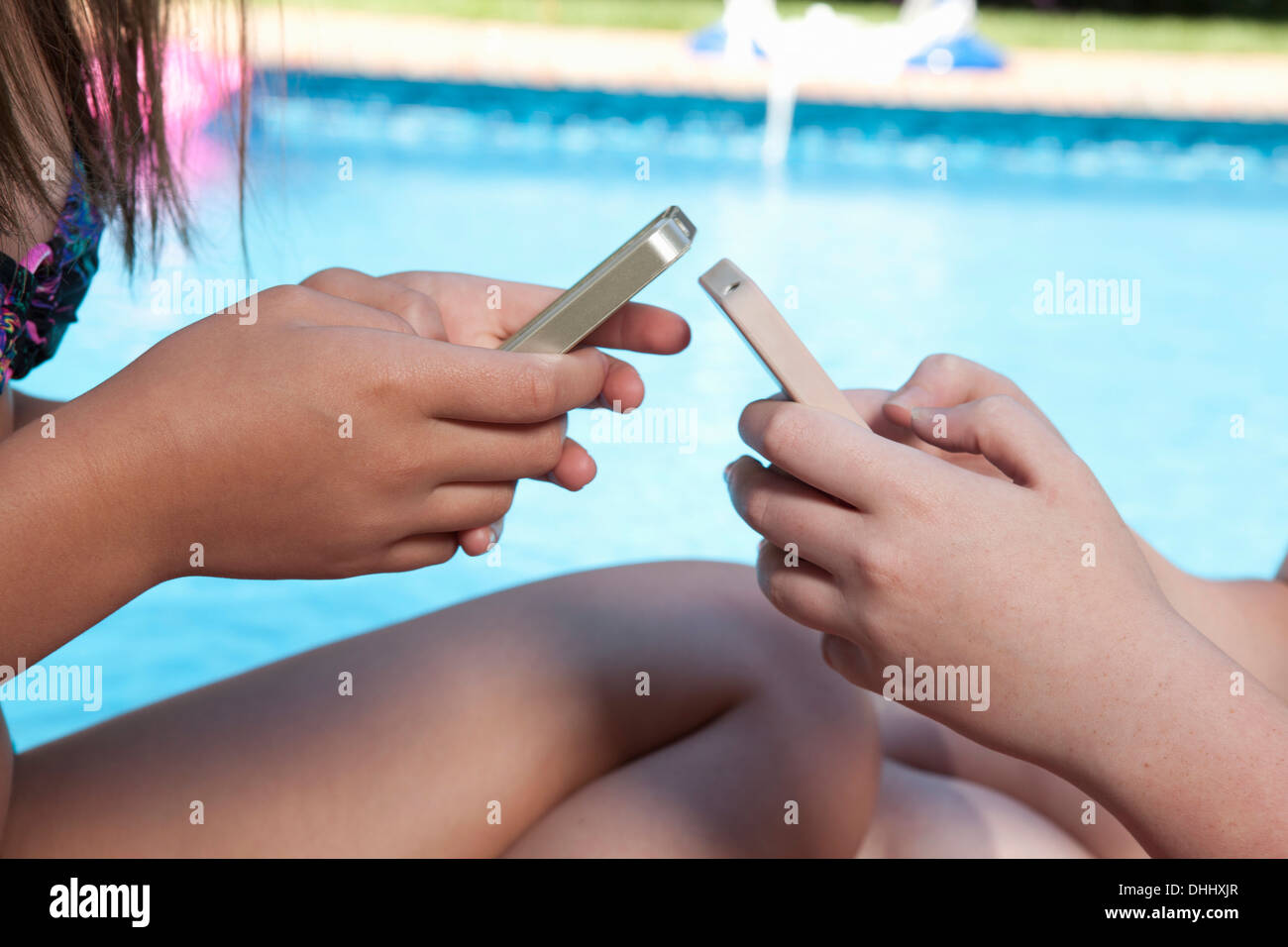 Friends texting on mobile phone Stock Photo