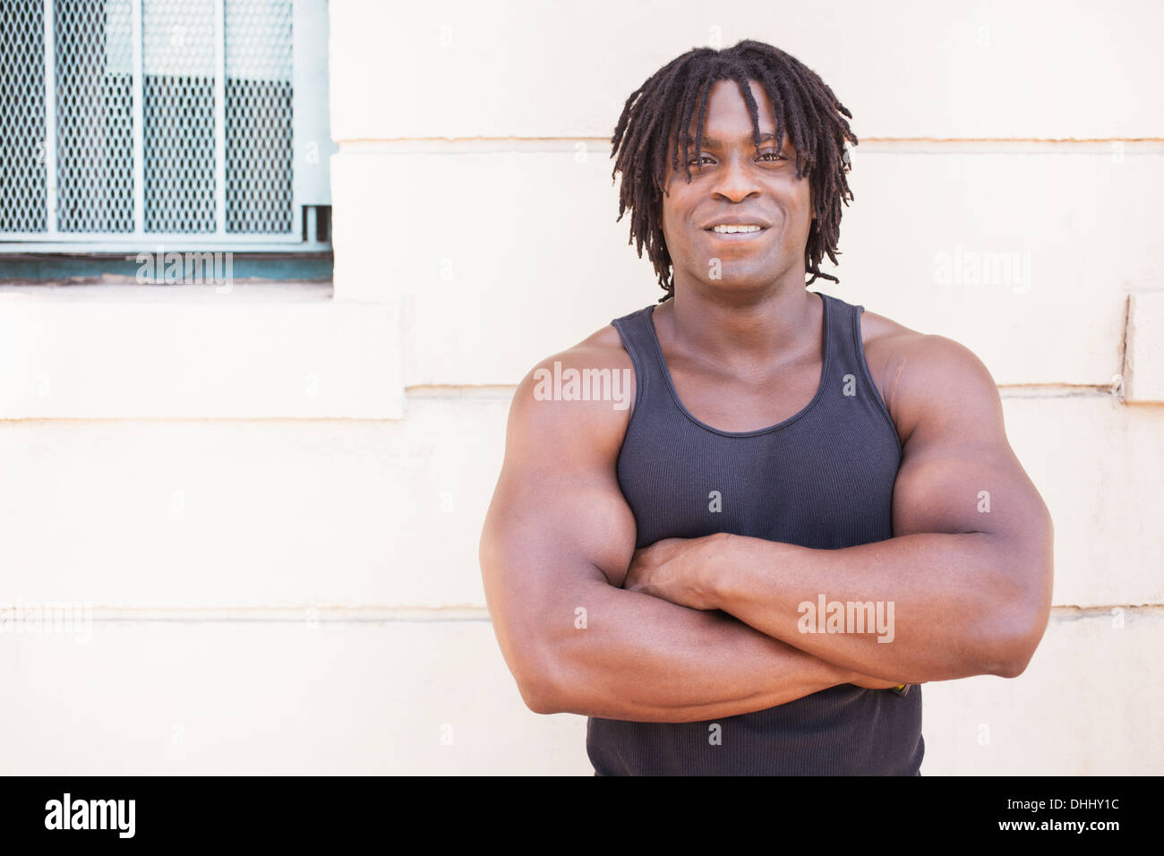 Black man stands arms hi-res stock photography and images - Alamy