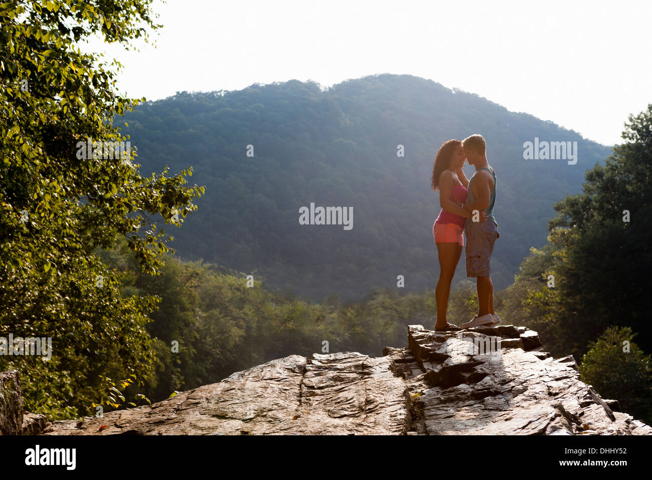 Young couple kissing on rock ledge, Hamburg, Pennsylvania, USA Stock Photo