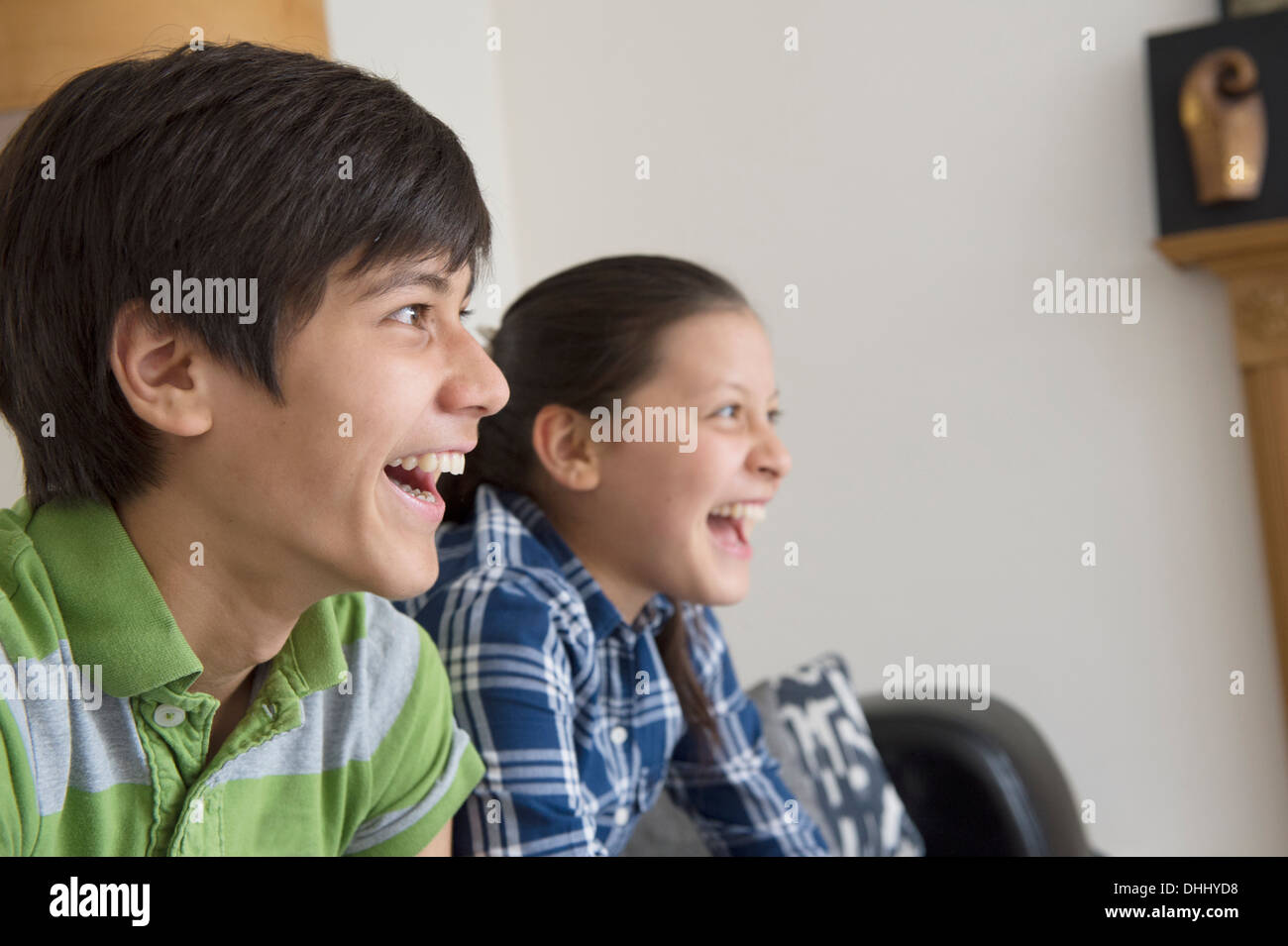 Brother and sister watching tv Stock Photo