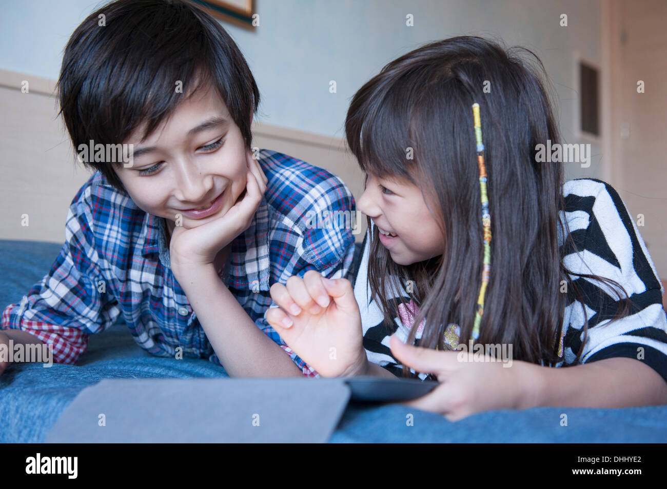 Brother and sister using digital tablet Stock Photo