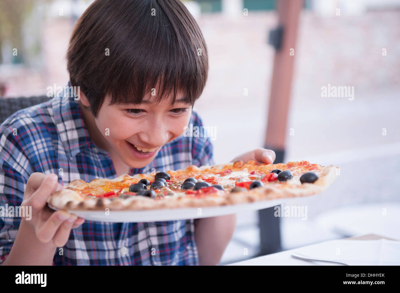 Boy holding pizza Stock Photo - Alamy