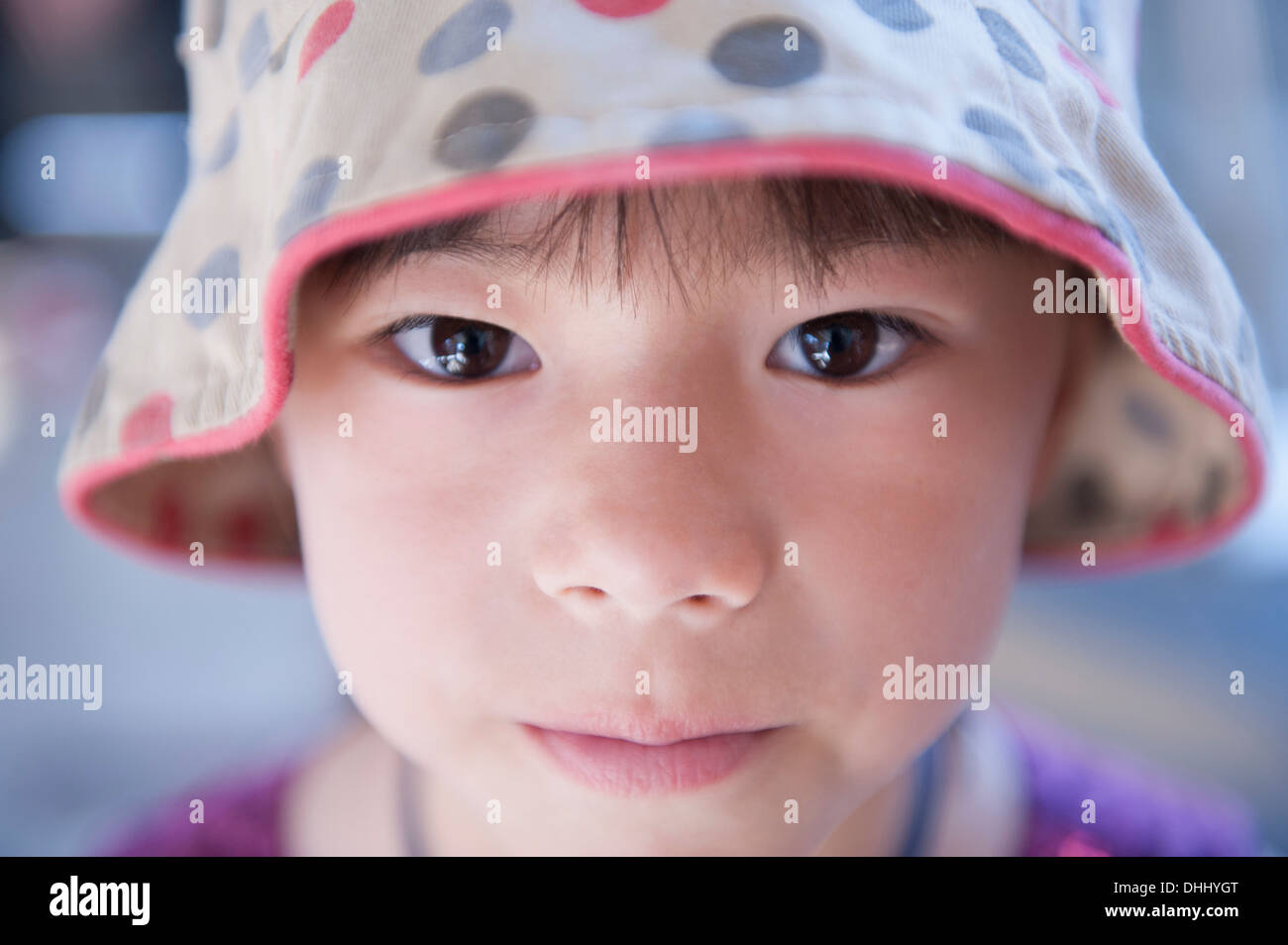 Portrait of girl wearing spotty beanie hat Stock Photo
