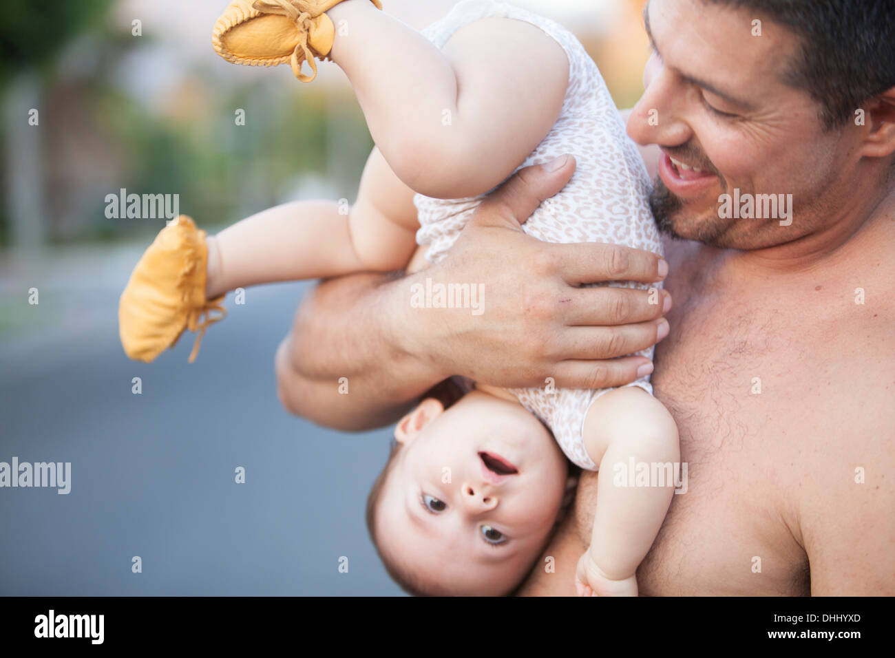 Grandfather holding baby granddaughter upside down Stock Photo Alamy