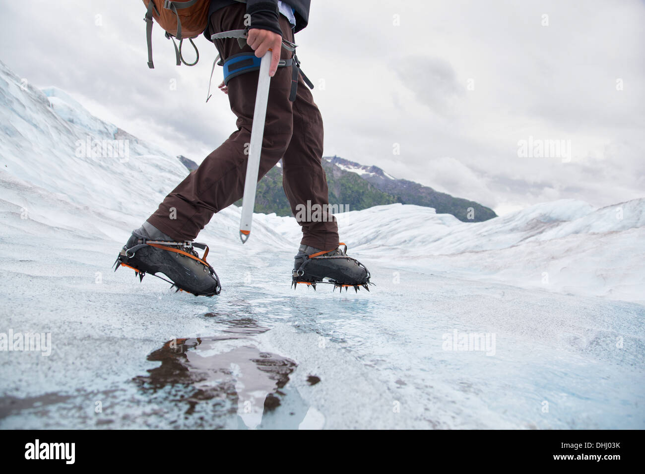 Young man walking on Mendenhall Glacier, Alaska, USA Stock Photo
