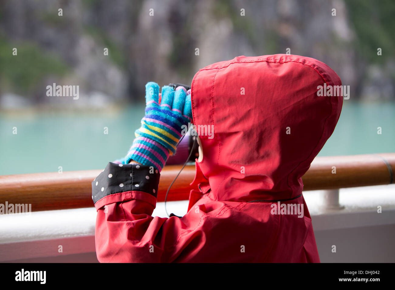 Young girl looking at glacier in Alaska from cruise ship, Ketchikan, Alaska, USA Stock Photo
