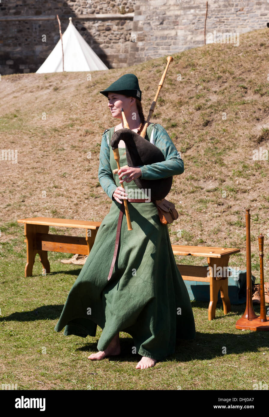 Woman in medieval costume playing the Bagpipes at Dover Castle Stock