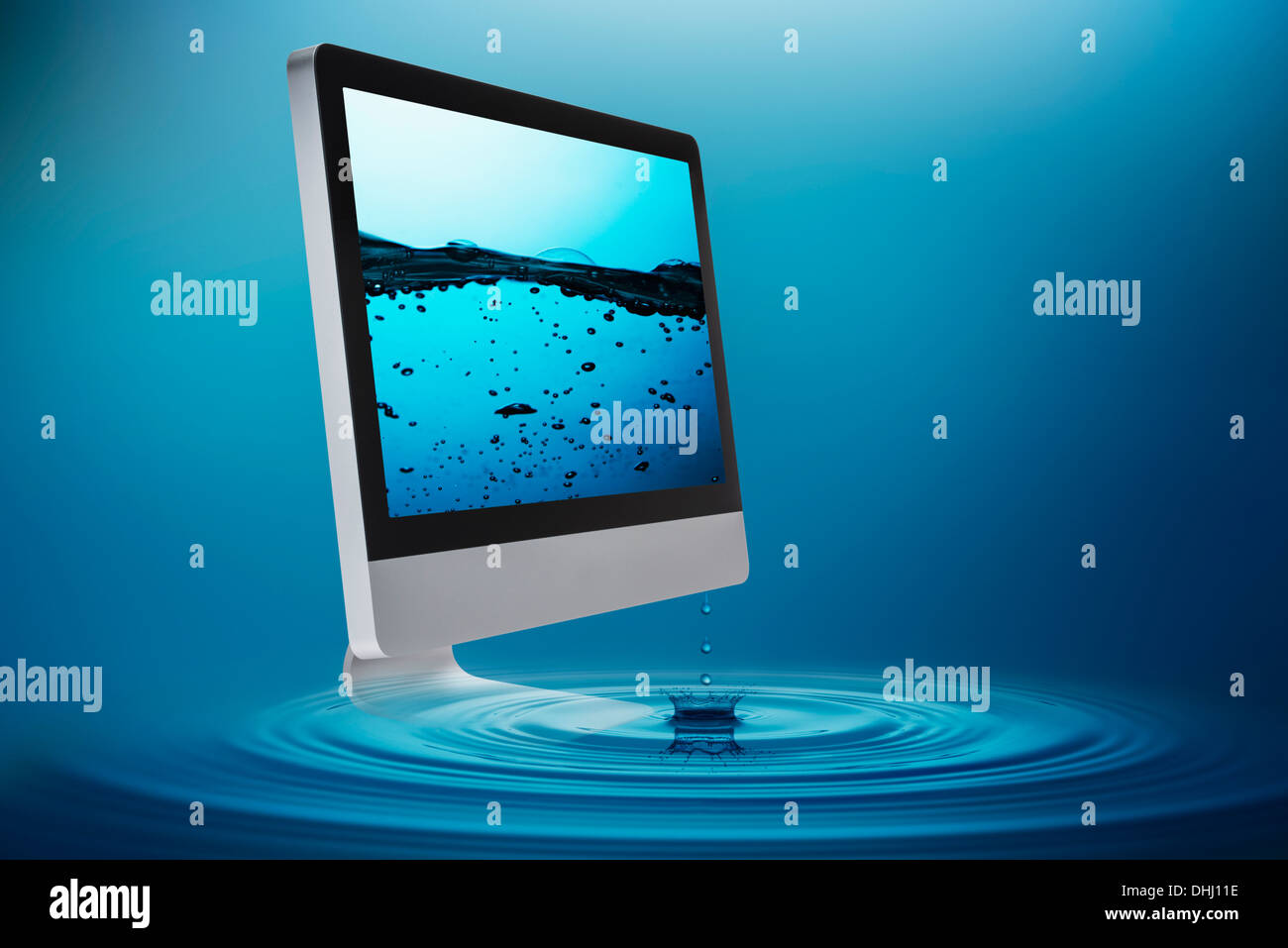 Still life with computer submerging in water Stock Photo - Alamy