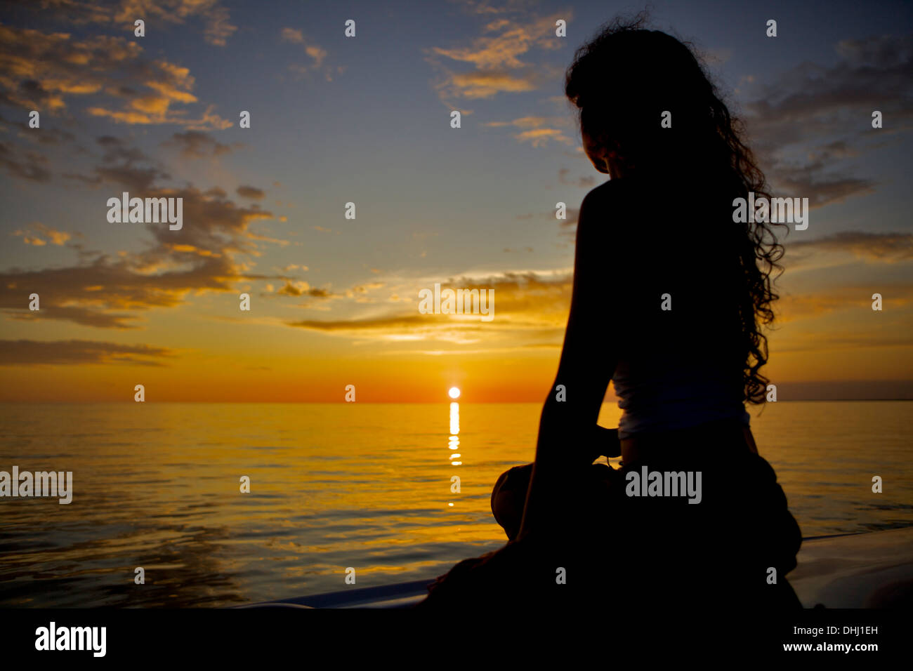 Silhouette of woman watching the sunset hi-res stock photography and ...