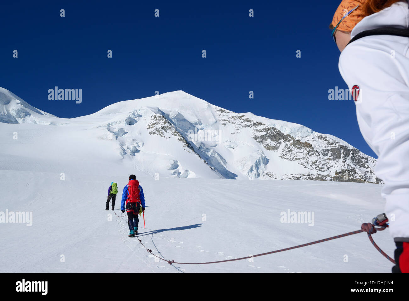 Three mountaineers ascending to Piz Palue, Grisons, Switzerland Stock Photo