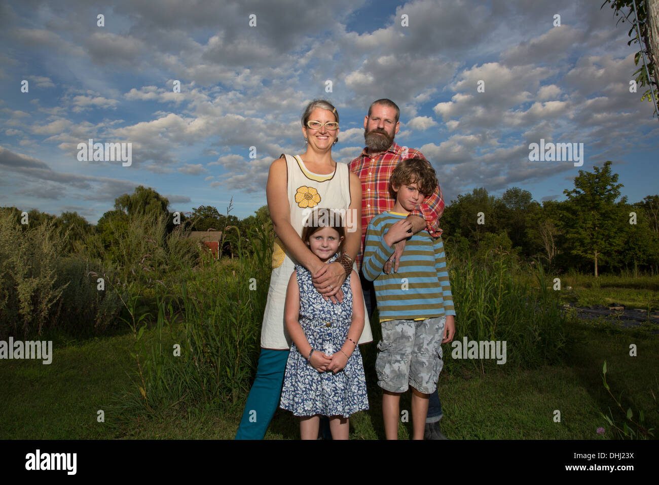 Portrait of couple with children on family herb farm Stock Photo