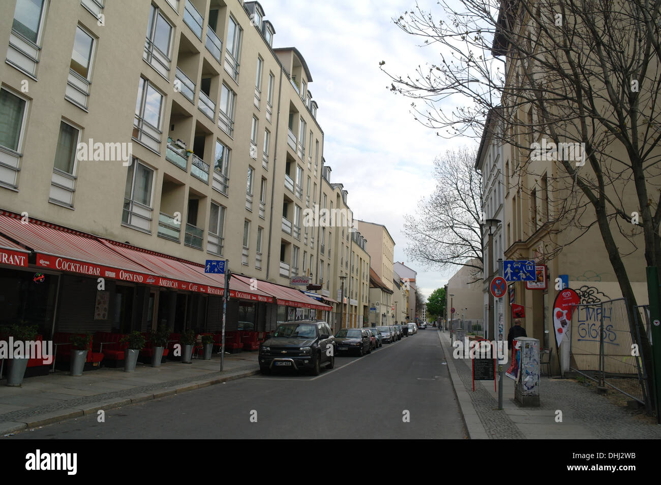 Grey sky dawn view, looking north, roadside cars, buildings rising, red ...