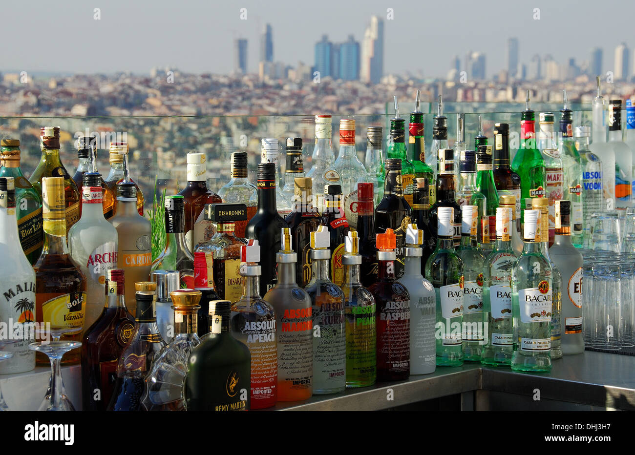 Lots of bottles of alcoholic spirits and liqueurs on a bar. Stock Photo