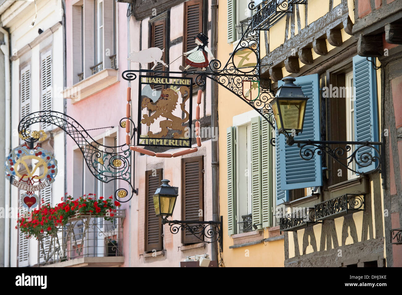 Colourful half timbered houses with decorative wroughtiron signs