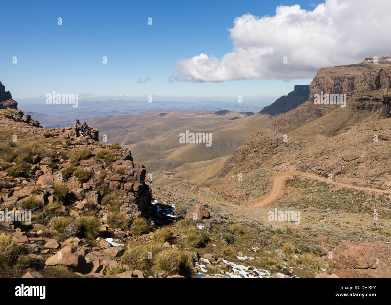 Africa landscape - Sani Pass Lesotho, South Africa.Two African boys sitting over the valley and winding road Stock Photo