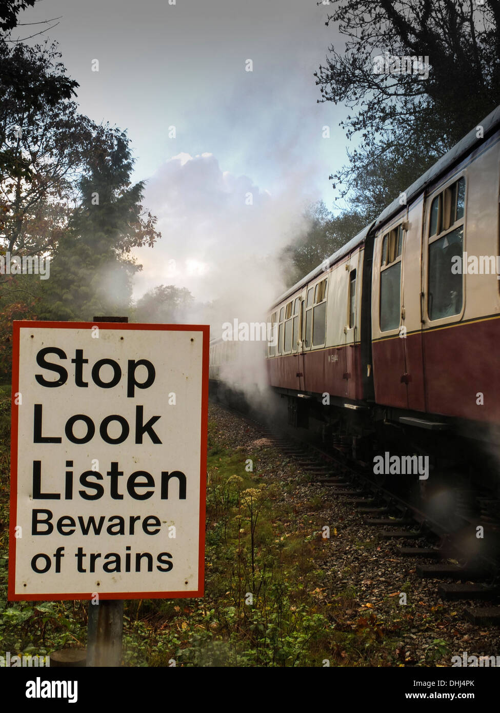 Safety sign on an old steam railway crossing on the Dart Valley Line. Staverton. Devon, UK Stock Photo