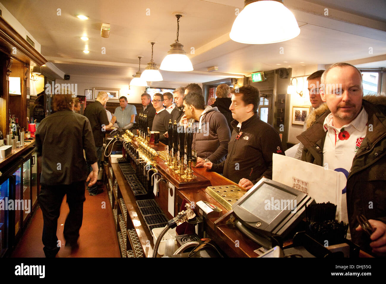 Men buying beer at the bar in the Princes Head Pub, Richmond, London UK